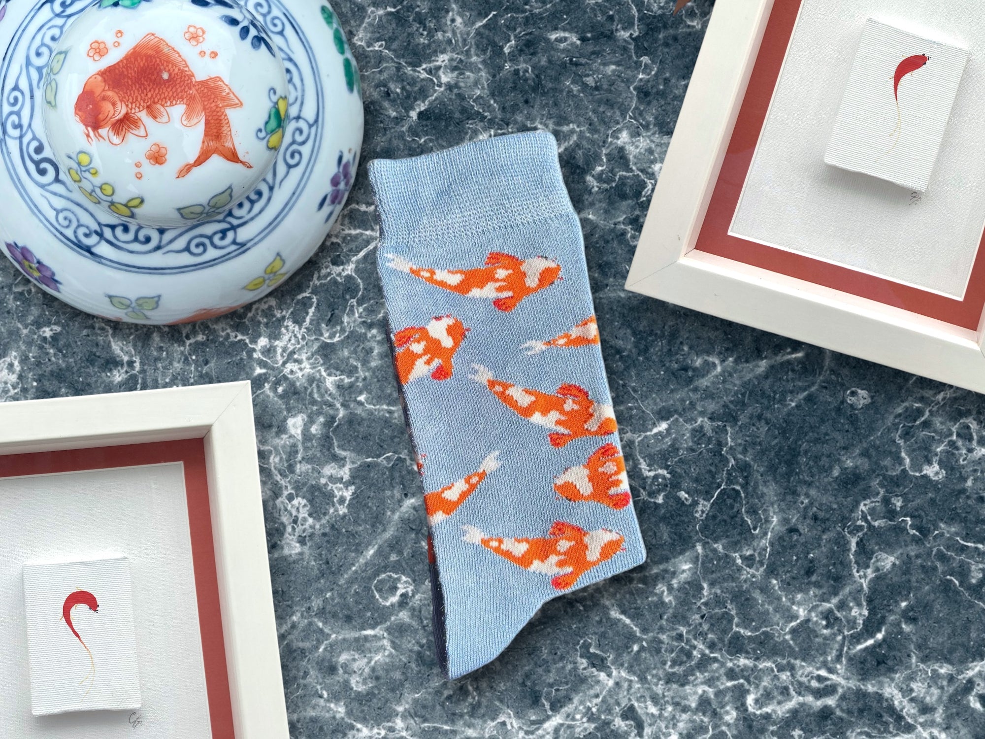 Koi Fish Pattern on a Light Blue Socks on a marble surface