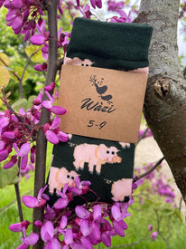 dark green bamboo socks with a pig design in a tree